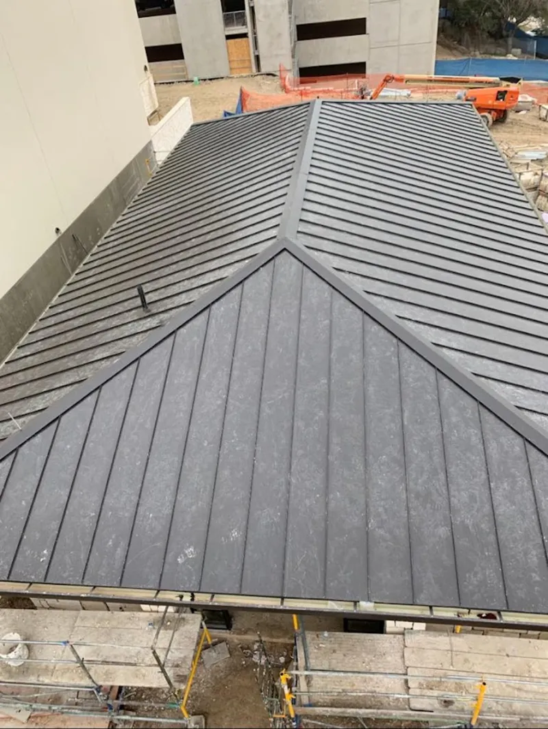 Commercial metal roof construction with crane equipment in Hazleton